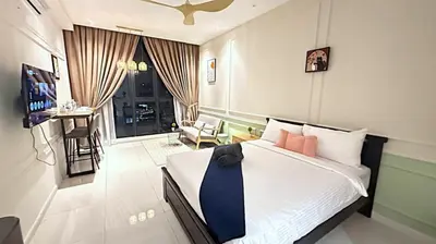 a bedroom with a bed with a blue tie on it at Majestic Residence Suites KLCC in Kuala Lumpur