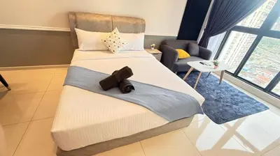 a bedroom with a large bed and a living room at Majestic Residence Suites KLCC in Kuala Lumpur