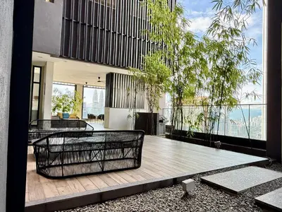 a house with a balcony with tables and trees at Lucentia residence bukit Bintang city centar in Kuala Lumpur