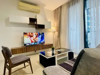 a living room with a tv and a couch at 1-5 people, Scandinavian Style Arcoris Mont Kiara in Kuala Lumpur