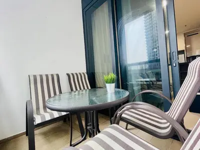 a table and chairs in a room with a window at 1-5 people, Scandinavian Style Arcoris Mont Kiara in Kuala Lumpur