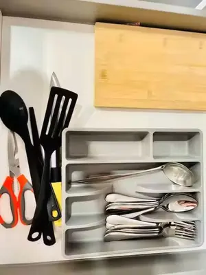 a drawer filled with utensils in a refrigerator at Max 5pax, Muji Style Apartment Arcoris Mont Kiara in Kuala Lumpur