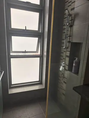 a shower in a bathroom with a window and a shower at Martin House KL in Kuala Lumpur
