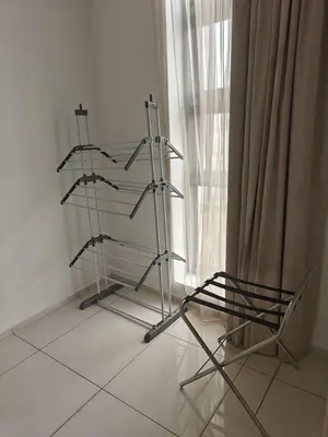 two metal shelves in a room with a window at Martin House KL in Kuala Lumpur