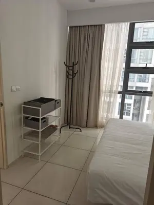 a white bedroom with a bed and a window at Martin House KL in Kuala Lumpur
