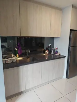 a kitchen with a sink and a refrigerator at Martin House KL in Kuala Lumpur