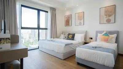a bedroom with two beds and a window at Alfa Bangsar by Guestonic in Kuala Lumpur