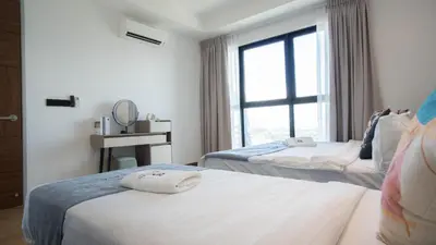 a hotel room with two beds and a window at Alfa Bangsar by Guestonic in Kuala Lumpur