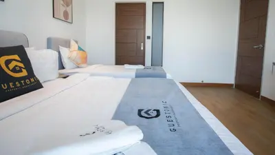 a hotel room with two beds with towels on them at Alfa Bangsar by Guestonic in Kuala Lumpur