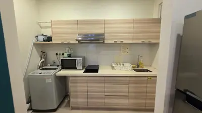 a small kitchen with a sink and a microwave at Binjai 8 KLCC Premium Soho By Prime Suites in Kuala Lumpur