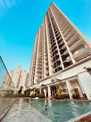a building with a swimming pool in front of a building at Quill Residences KLCC By ONZO in Kuala Lumpur
