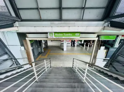 an airport hallway with stairs and a sign that reads modern transit at Quill Residences KLCC By ONZO in Kuala Lumpur