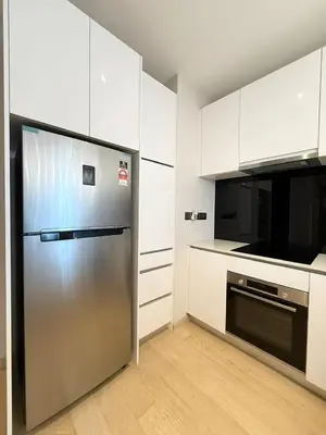 a kitchen with a stainless steel refrigerator and white cabinets at Star Residence Heart of KLCC in Kuala Lumpur