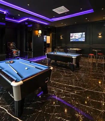a billiard room with two pool tables and a screen at Star Residence Heart of KLCC in Kuala Lumpur