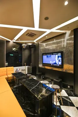 a restaurant with tables and chairs and a flat screen tv at Star Residence Heart of KLCC in Kuala Lumpur