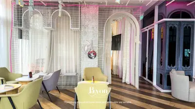 a room with chairs and a candle on a table at Ceylonz Premium Suites KLCC by BYON in Kuala Lumpur