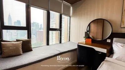 a bedroom with a bed and a mirror and some windows at Ceylonz Premium Suites KLCC by BYON in Kuala Lumpur