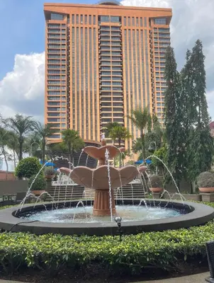 a fountain in front of a large building at Elegant Apartment at Times Square in Kuala Lumpur