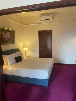 a bedroom with a large white bed and purple carpet at Elegant Apartment at Times Square in Kuala Lumpur