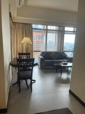 a living room with a table and a couch at Elegant Apartment at Times Square in Kuala Lumpur