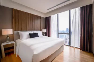 a bedroom with a large white bed and a large window at Imperial KLCC by WSD in Kuala Lumpur