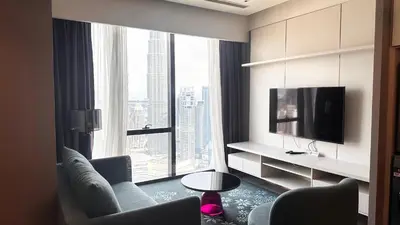 a living room with a tv and a large window at Imperial KLCC by WSD in Kuala Lumpur