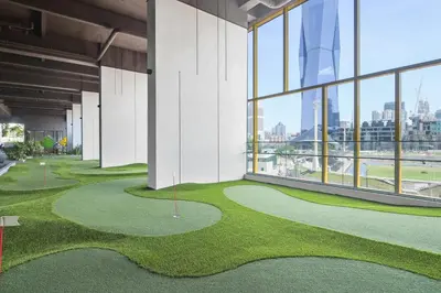 a golf course in a building with a view of the city at Opus Kuala Lumpur by WSD in Kuala Lumpur