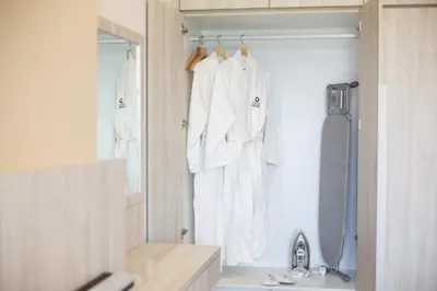 a bathroom with a sink and a shower and white towels at Opus Kuala Lumpur by WSD in Kuala Lumpur
