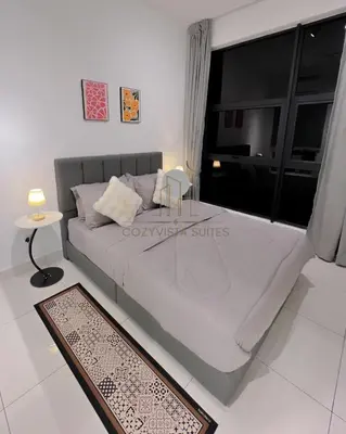 a bedroom with a large bed with a large window at Arte Mont Kiara by CozyVista Suites in Kuala Lumpur