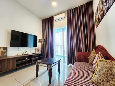 a living room with a couch and a flat screen tv at RC Residence 6 pax by Define Suite in Kuala Lumpur