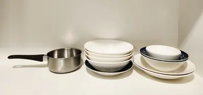 a pile of plates and bowls and a pot at RC Residence 6 pax by Define Suite in Kuala Lumpur