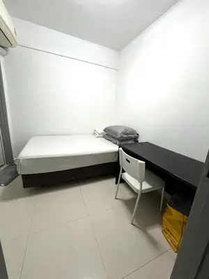 a bedroom with a bed and a desk and a chair at Apartment in bukit bintang in Kuala Lumpur