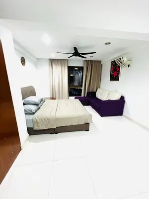 a living room with a bed and a couch at Apartment in bukit bintang in Kuala Lumpur