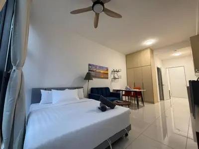 a bedroom with a white bed and a ceiling fan at Royale Suites At Majestic Residence KL in Kuala Lumpur