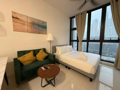 a bedroom with a bed and a couch and a table at Royale Suites At Majestic Residence KL in Kuala Lumpur