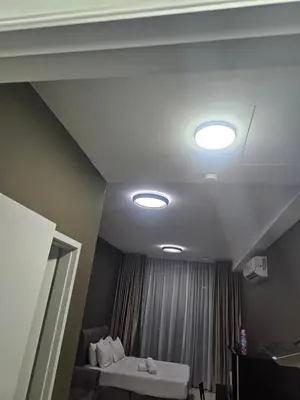 a room with three lights on the ceiling at Royale Suites At Majestic Residence KL in Kuala Lumpur