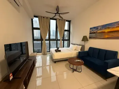 a living room with a couch and a tv at Royale Suites At Majestic Residence KL in Kuala Lumpur