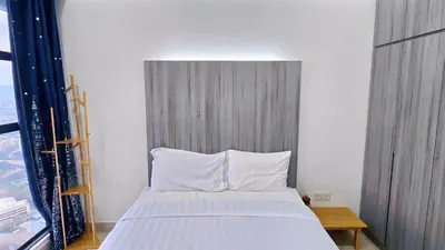 a bed with white pillows in a room at Trion KL Star Suites in Kuala Lumpur