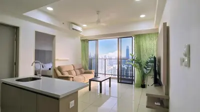 a kitchen and living room with a view of the city at Trion KL Star Suites in Kuala Lumpur