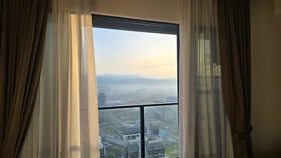 a window in a hotel room with a view of a city at Trion KL Star Suites in Kuala Lumpur