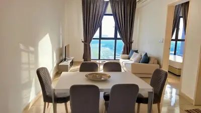 a living room with a table and chairs and a couch at Trion KL Star Suites in Kuala Lumpur