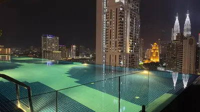 a view of a city skyline at night at Private family suite 1113A1BR at Majestic Residence in Kuala Lumpur