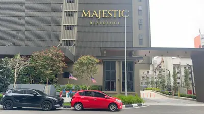 two cars parked in a parking lot in front of a building at Luxury suite for couple 267A at KLCC in Kuala Lumpur