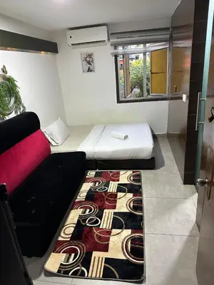 a small room with a bed and a rug at Moonlight Inn Bukit Bintang in Kuala Lumpur