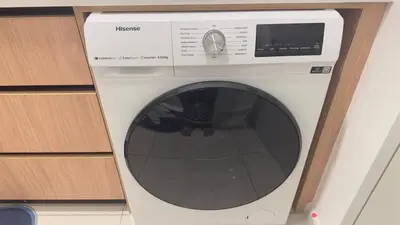 a white washing machine sitting in a kitchen at Luxury suite 293A at KLCC in Kuala Lumpur