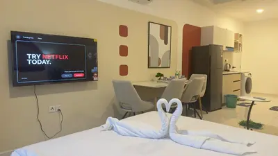 a room with a tv on the wall with swans on a bed at Luxury suite 293A at KLCC in Kuala Lumpur