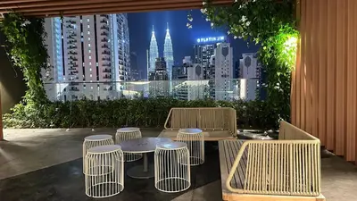 a table and chairs with a view of a city at Luxury suite 293A at KLCC in Kuala Lumpur