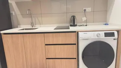 a kitchen with a sink and a washing machine at Luxury suite 293A at KLCC in Kuala Lumpur