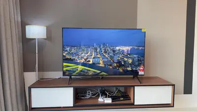 a flat screen tv sitting on top of a entertainment center at Private family apartment 27131BR at Majestic Residence in Kuala Lumpur