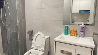a bathroom with a shower and a toilet and a sink at Private family apartment 27131BR at Majestic Residence in Kuala Lumpur